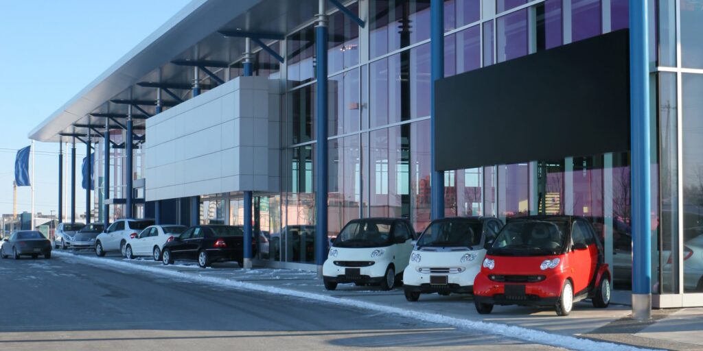 A fleet of commercial vehicles including utes, sedans, and trucks parked in formation, representing comprehensive motor fleet insurance coverage.