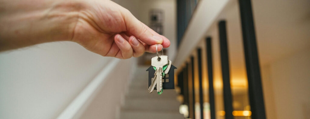 Person holding house keys representing landlord insurance and residential property protection in Australia