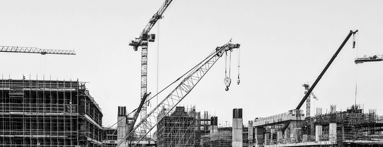 Large construction site with cranes representing construction insurance and project risk management