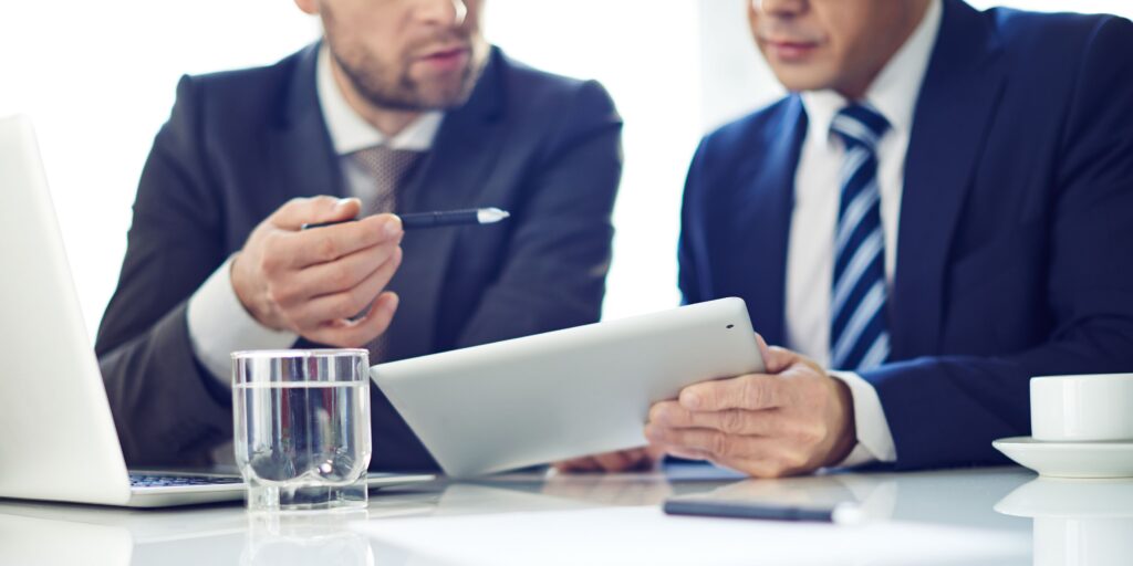 Business professionals reviewing financial data and business insurance requirements in a high interest rate environment